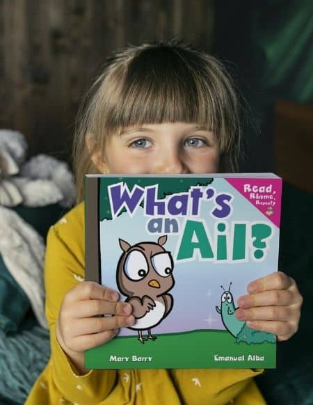 Small girl shows book "What's an Ail?"
